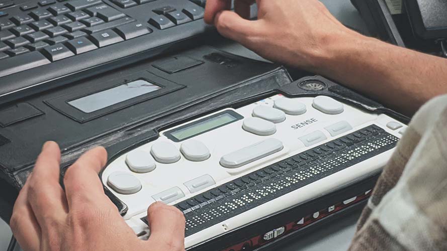 Braille display being used with SuperNova on a laptop