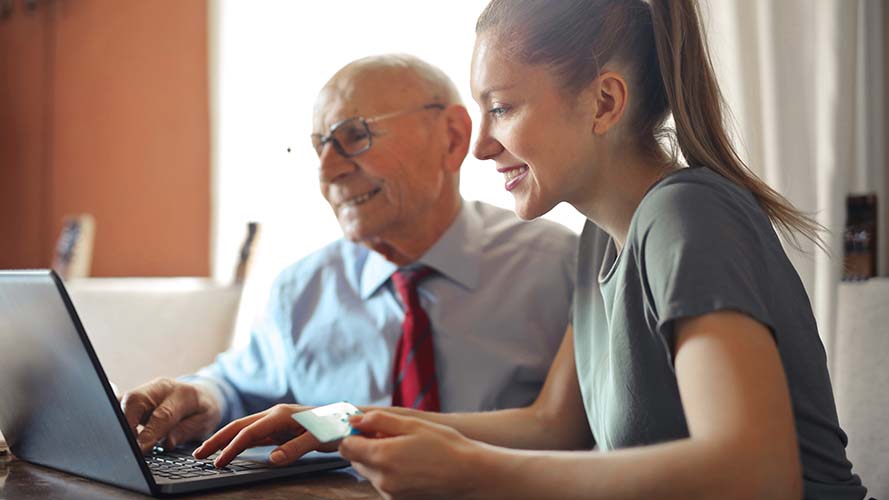 Different generations learning to use a laptop