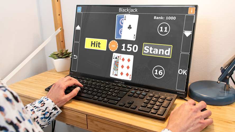 Image of a person sat at a computer playing blackjack with GuideConnect